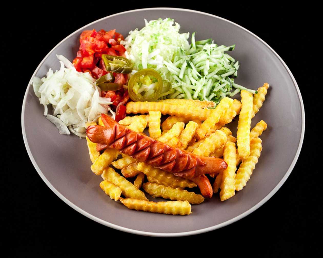 French fries with sausages and vegetables