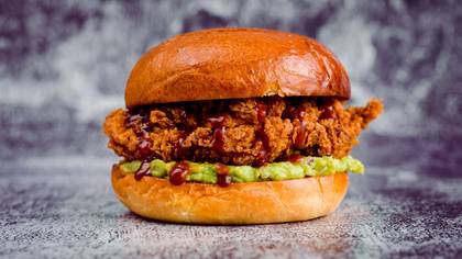 Spicy burger with guacamole and crispy chicken