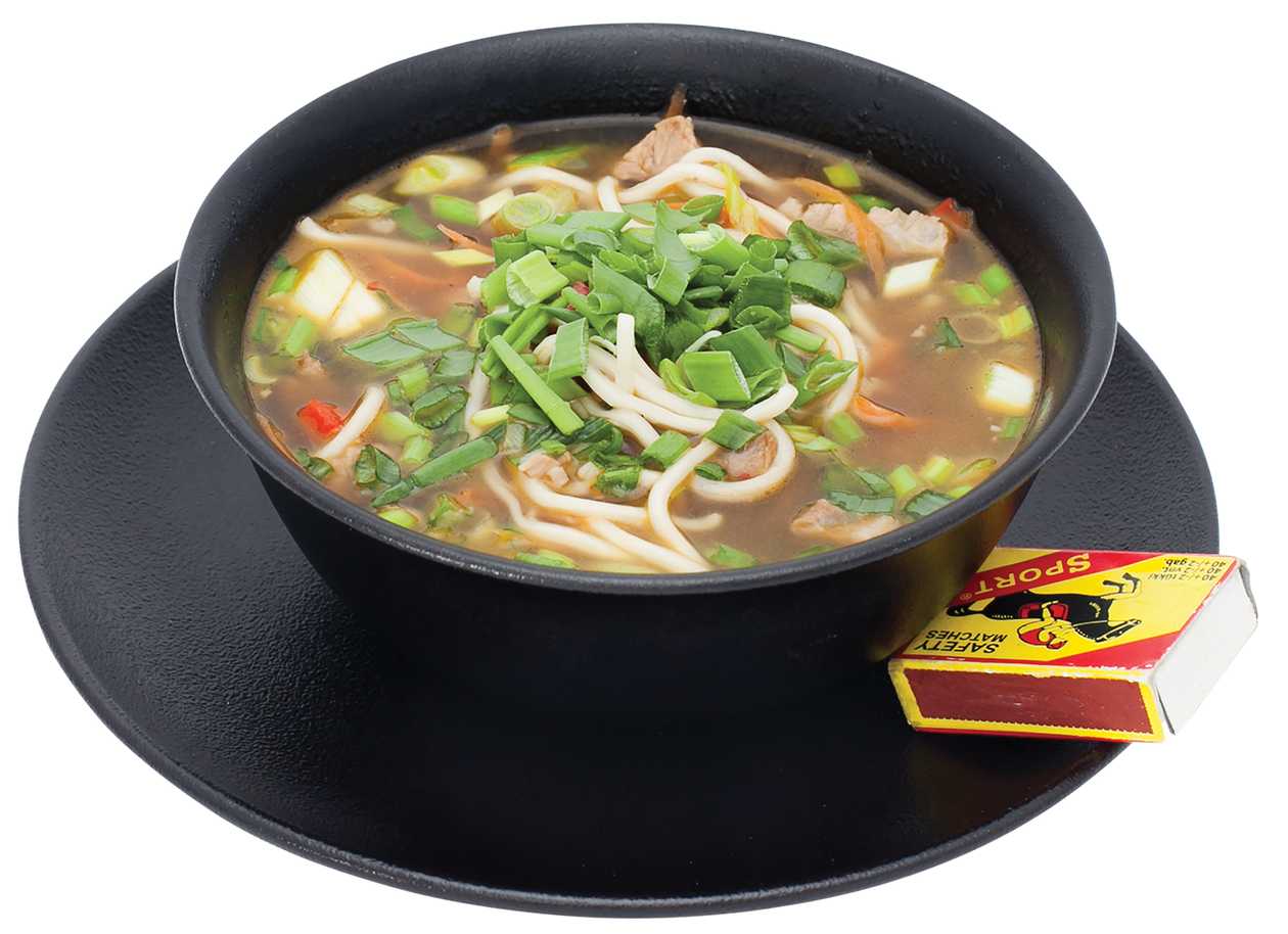 Pork broth soup with egg noodles and vegetables