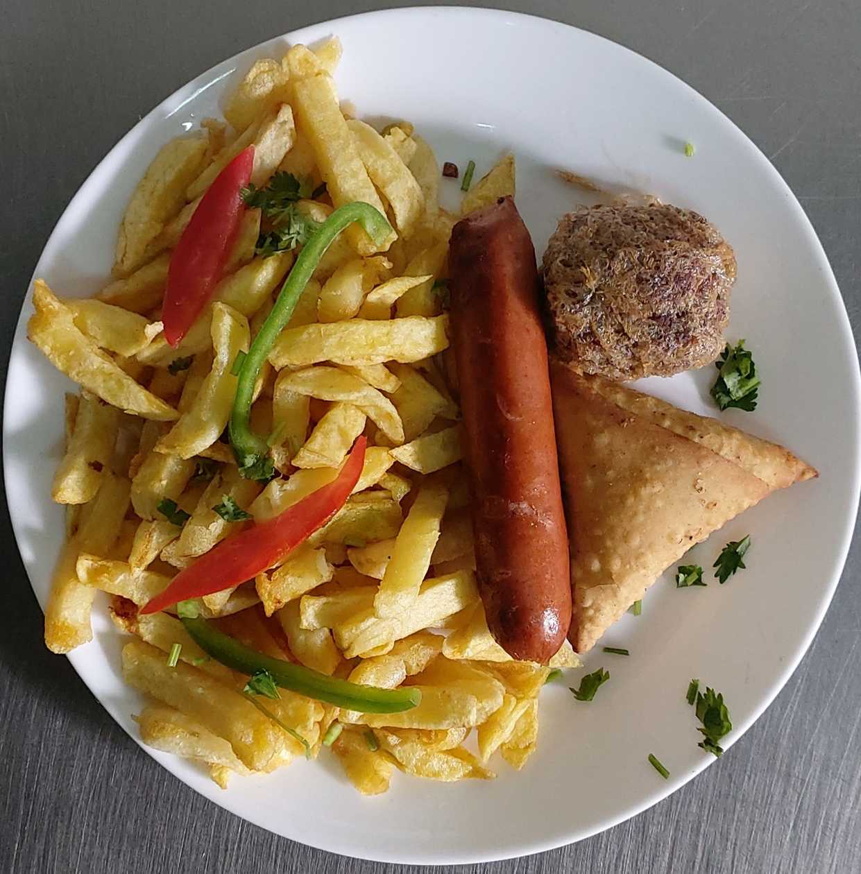 French fries with choma sausage,meatball and samosa.