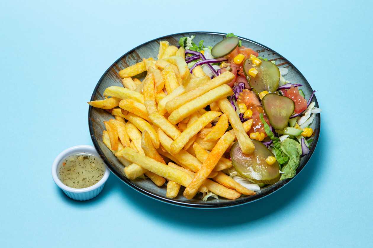 French fries with fresh vegetable salad