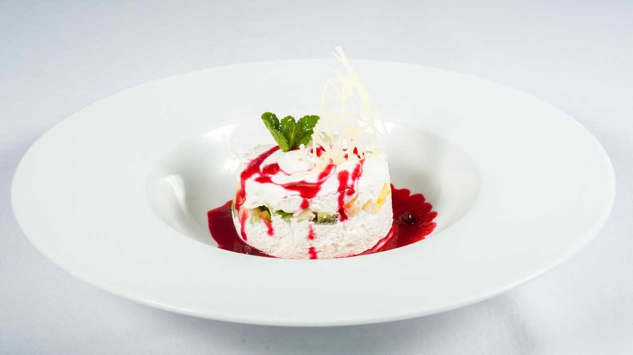 Curd cream with fruit and raspberry sauce