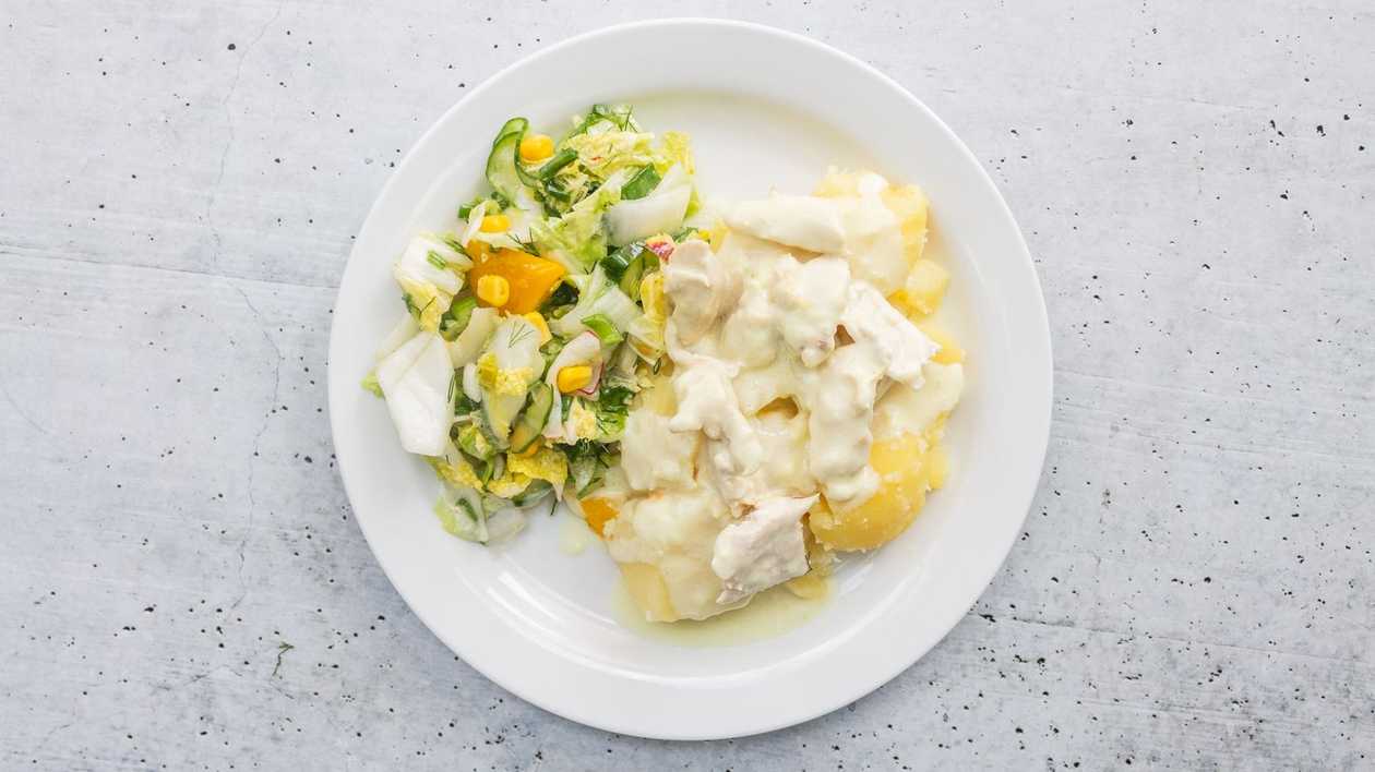 Pieces of chicken fillet in cheese sauce with boiled potatoes