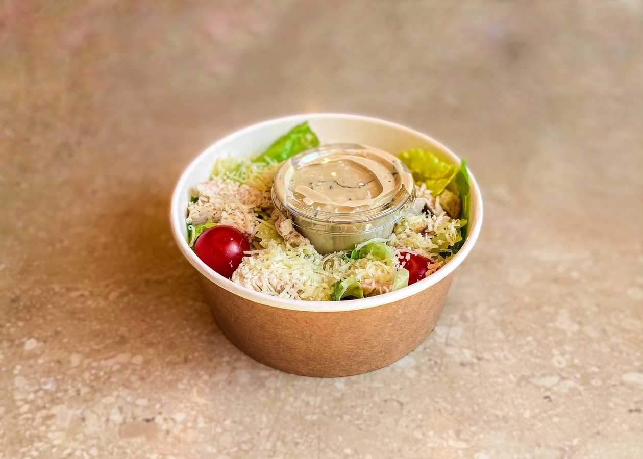 Caesar salad with pieces of grilled chicken
