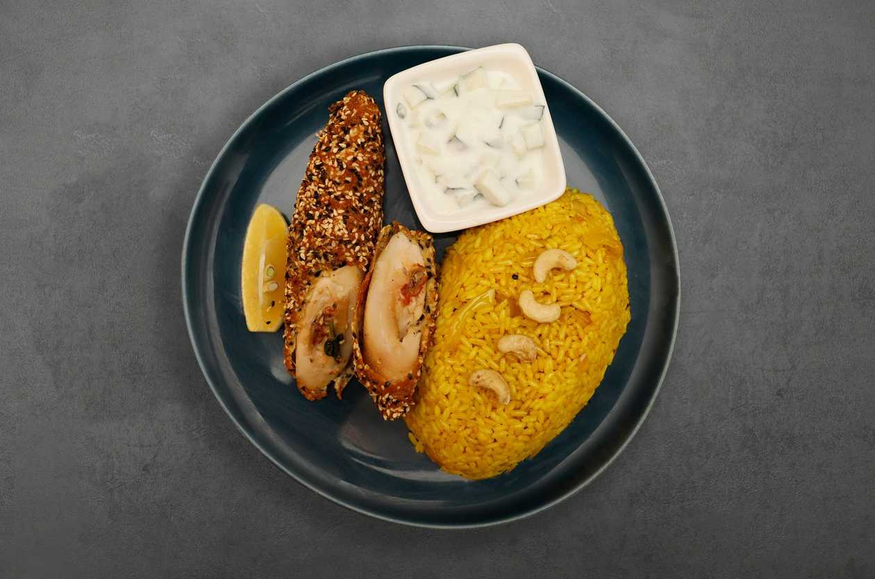 Zagreb steak rolled in sesame, biryani rice, tzatziki salad