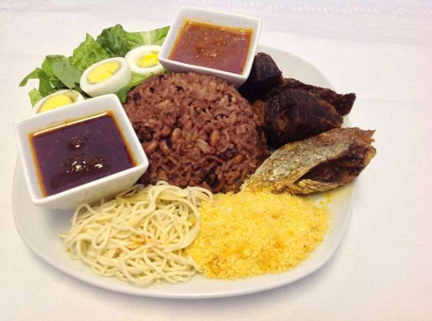 Waakye with Macaroni, Egg, Gari, Salad and Fish