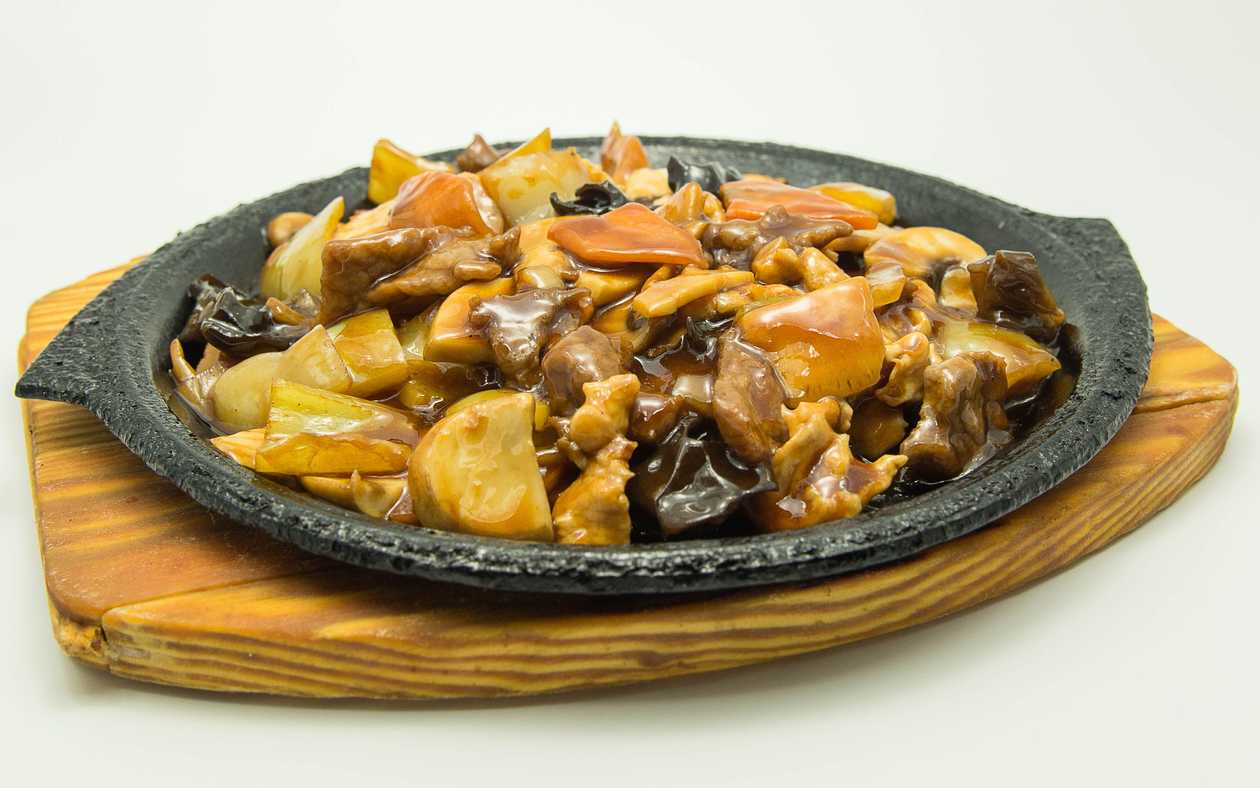 Beef and chicken on a hot stove