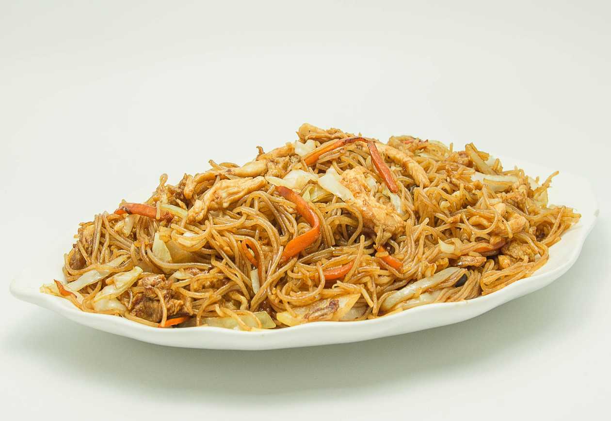 Fried rice noodles with chicken, vegetables and egg