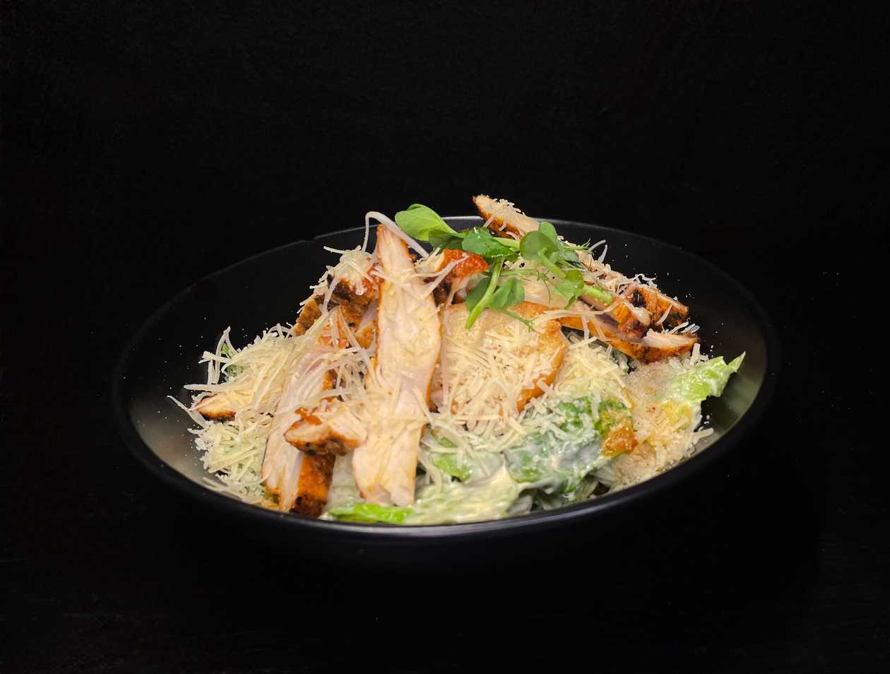 Roman lettuce with caesar dressing and parmesan cheese with grilled chicken fillet