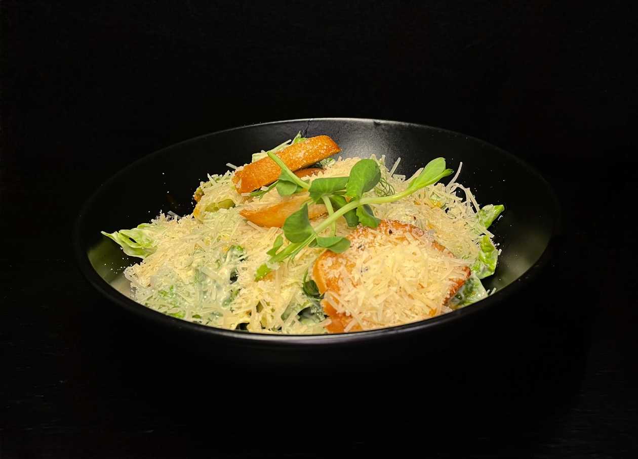 Roman lettuce with caesar dressing and parmesan cheese