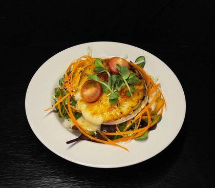 Fresh salad with mango salad dressing with camembert cheese