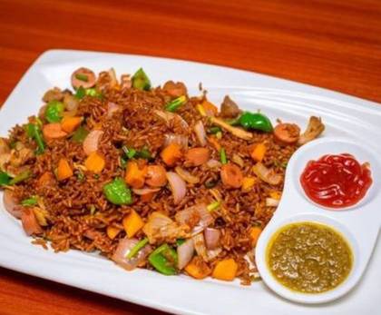 Assorted jollof with sausage and fried plantain
