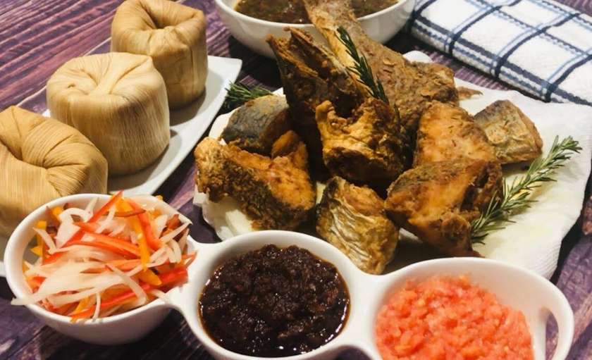 Kenkey or  Banku with  fried chicken and fried eggs plus  hot pepper (red and black)