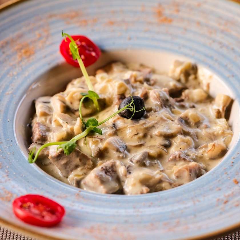 Beef tongue with mushrooms in cream sauce