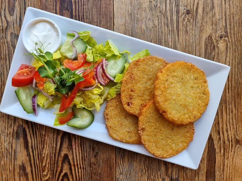 Potato pancakes with cream and lettuce