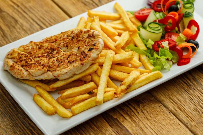 Grilled chicken breast with French fries