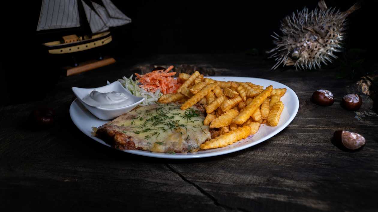 Pork chop with cheese and side dish
