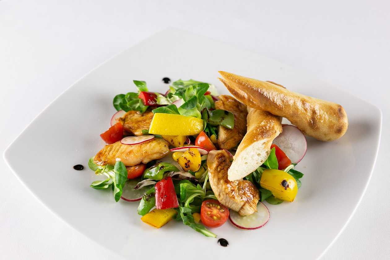 Colorful mixed salad, pizza rolls