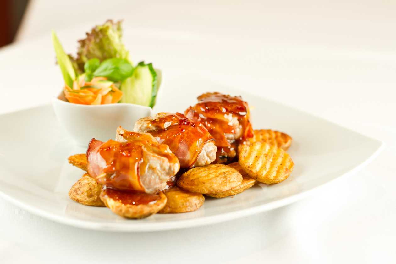 Grilled pork spirals with bacon on a skewer, American special potatoes