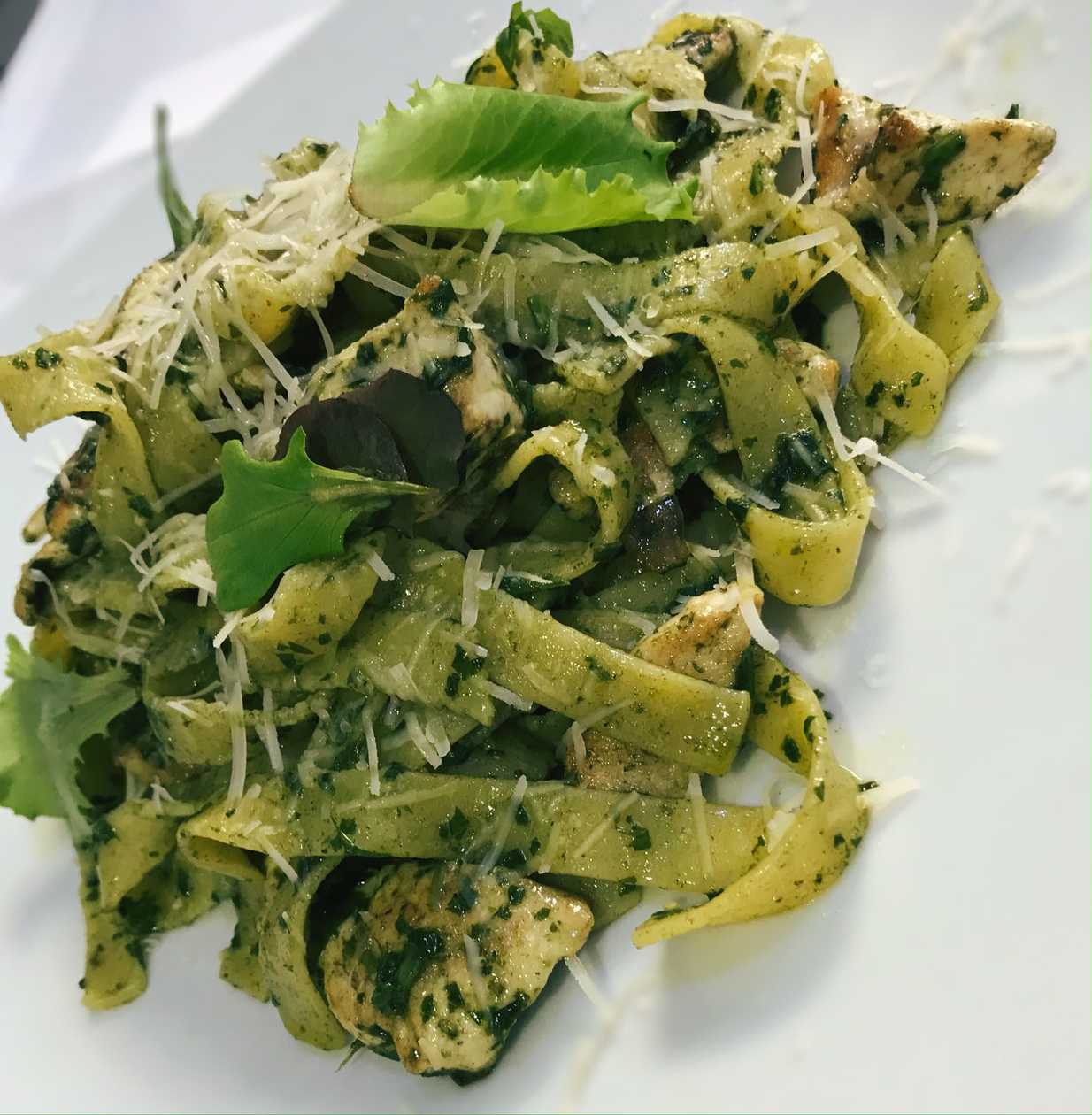 Tagliatelle with homemade basil pesto, pine nuts, dried tomatoes and parmesan