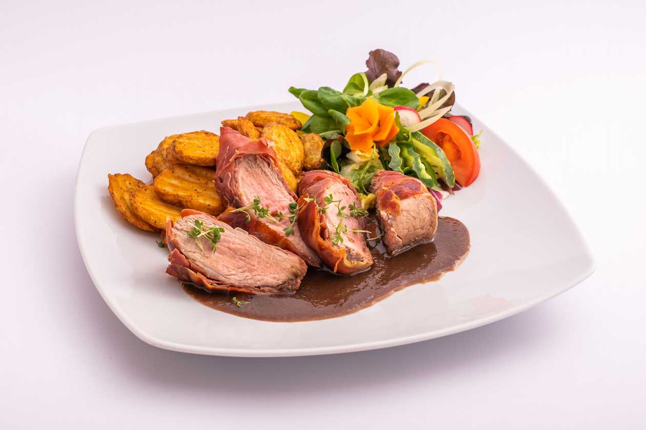 Grilled pork tenderloin in prosciutto