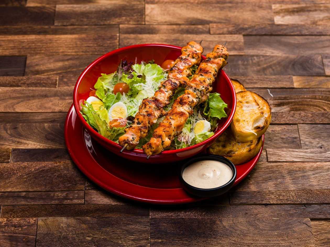 Ceasar salad with skewered salmon fillet