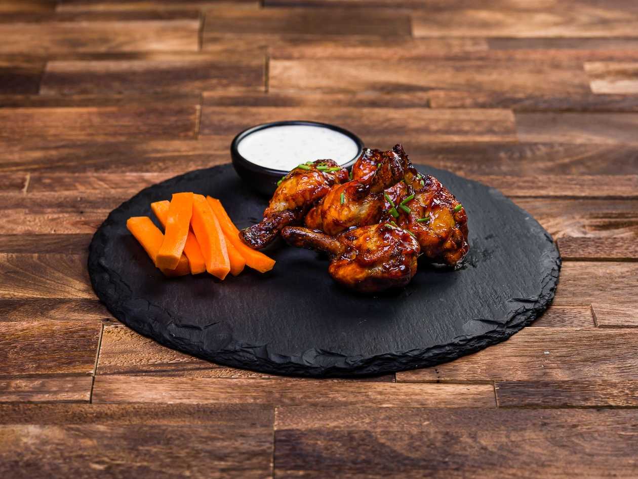 Chicken wings - With carrot straws and Tzatziki sauce. Glaze optional: BBQ, Jameson
