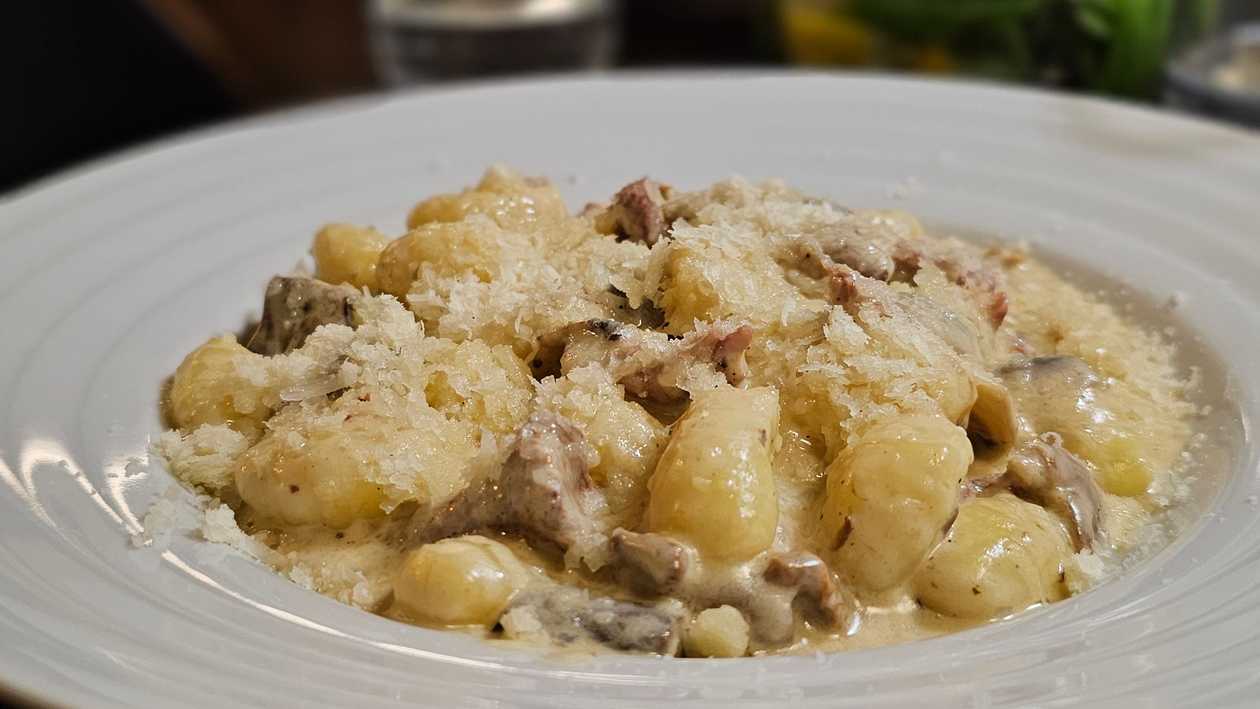 Gnocchi con prosciutto, salsa di funghi porcini
