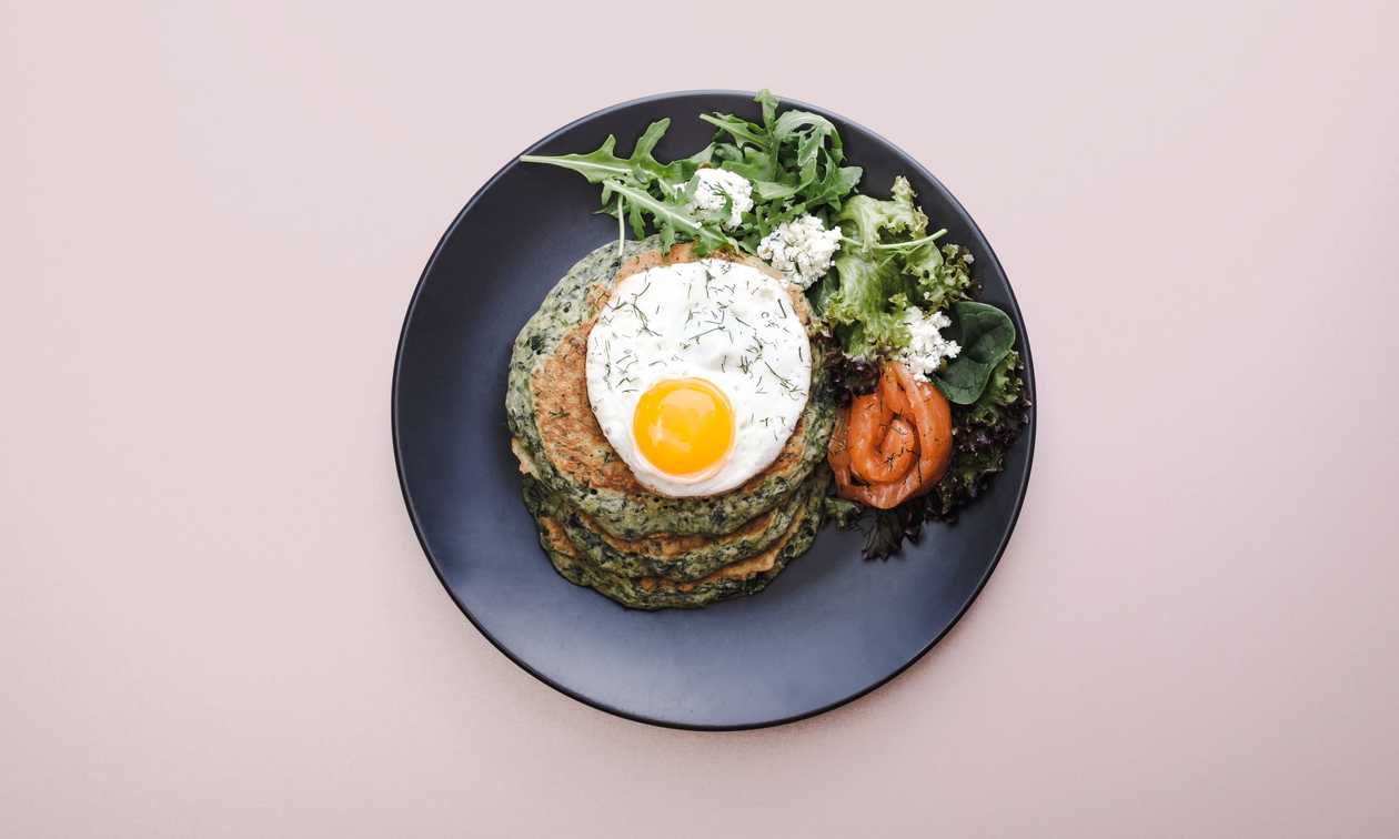 Spinach american pancakes with salted salmon, savory cottage cheese and fried egg