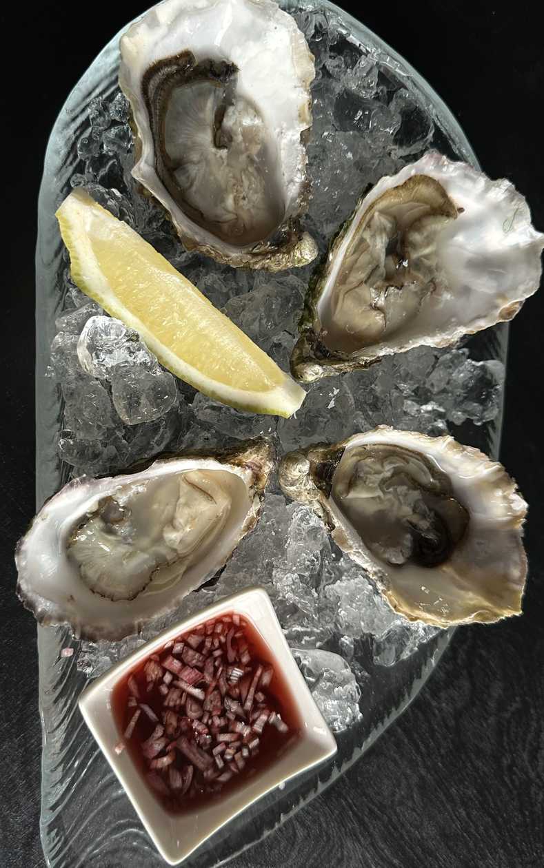 Fresh oysters with classic sauce and black toast with truffle oil 1 piece