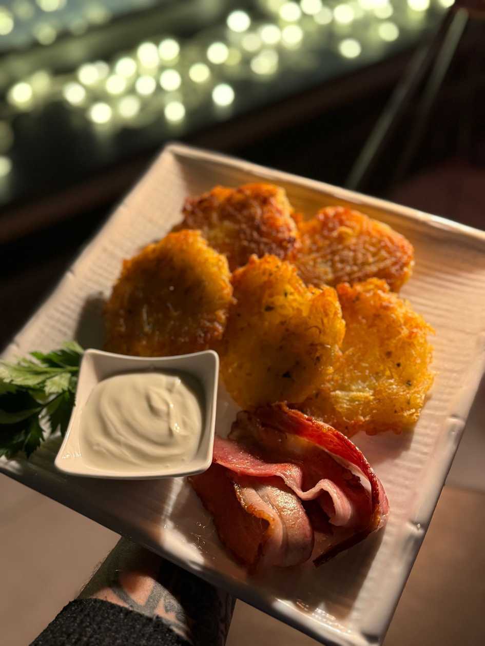 Potato pancakes with crispy fried bacon
