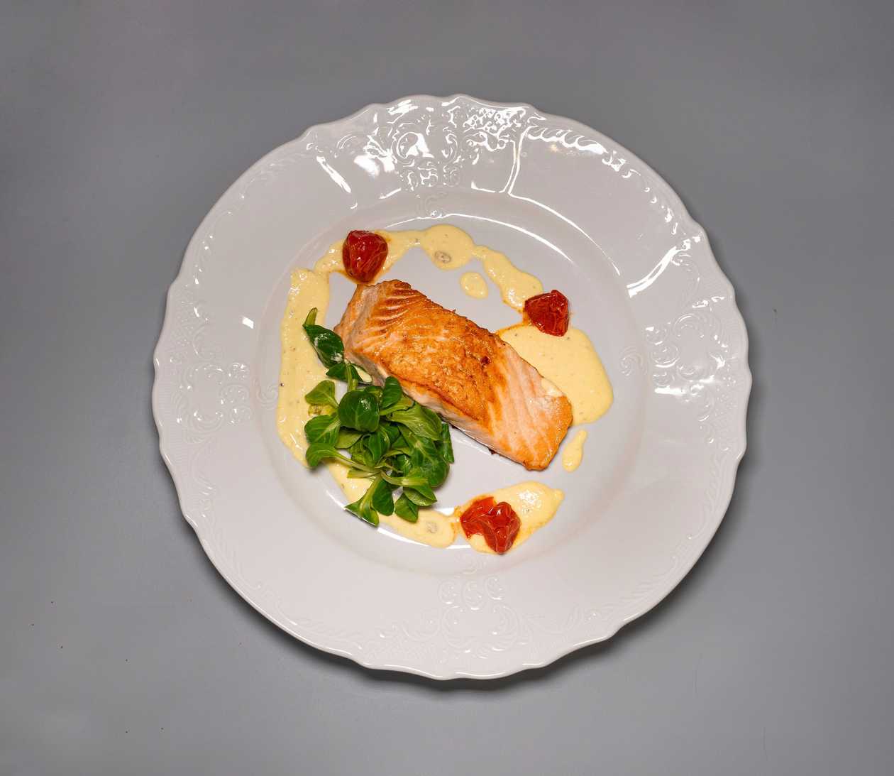 Grilled salmon fillet, lemon-turmeric sauce, roasted cherry tomatoes