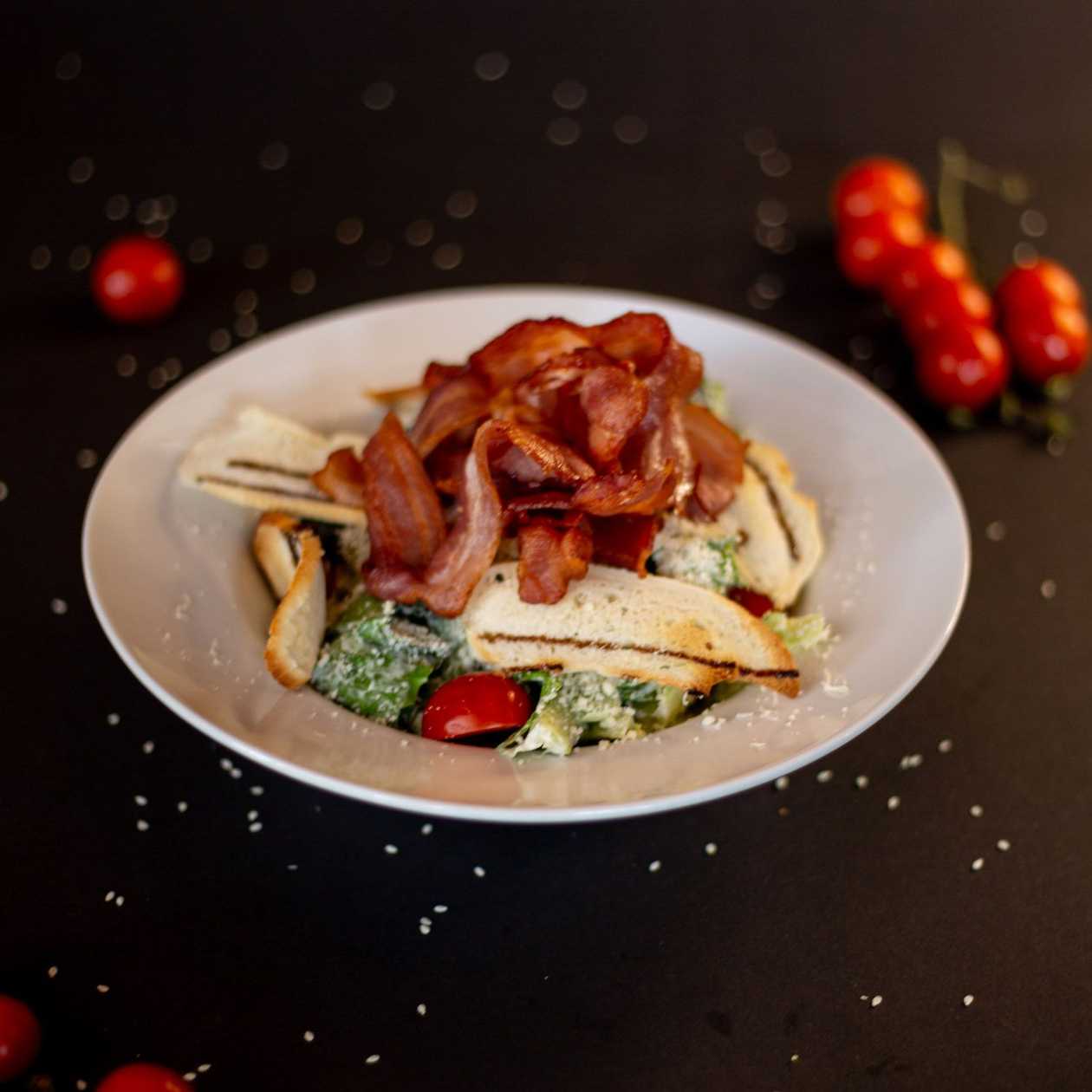 Caesar salad with bacon and cherry tomatoes