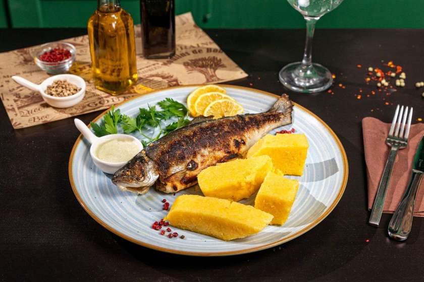 Grilled trout with polenta and garlic sauce