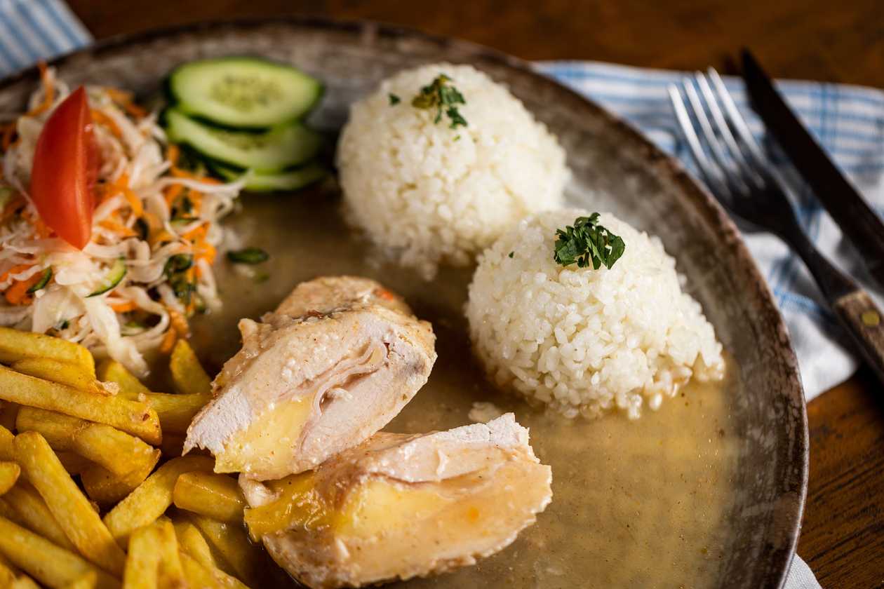 Natural chicken roll with ham and cheese, 1/2 rice, 1/2 fries, vegetable garnish