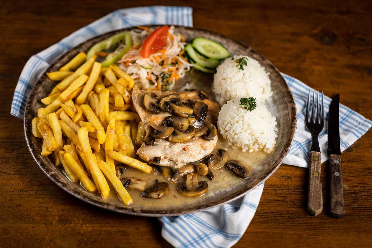 Natural chicken slice on champignons, 1/2 rice, 1/2 fries, vegetable garnish