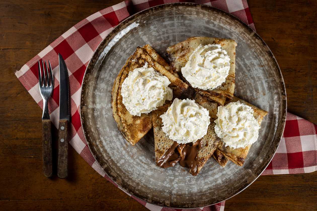 Pancakes filled with Nutella with whipped cream