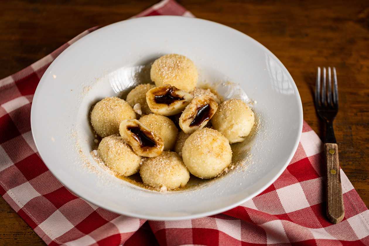 Stuffed fruit balls topped with butter and breadcrumbs