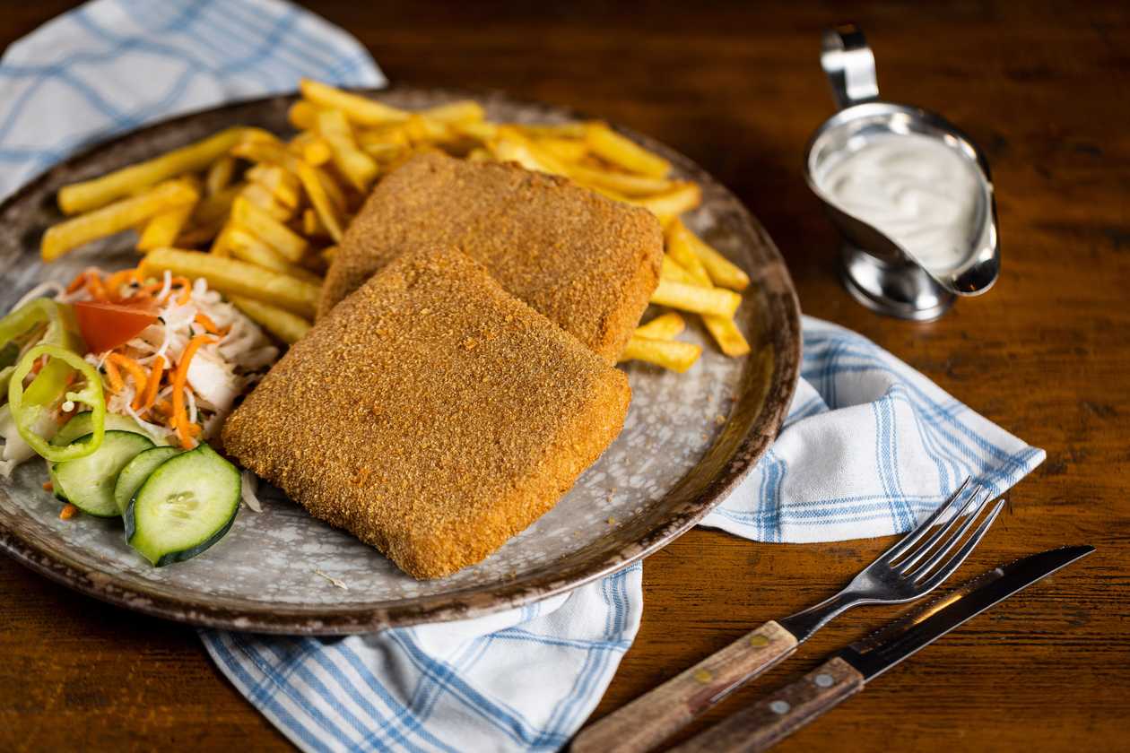 Fried cheese with ham, fries, vegetable garnish