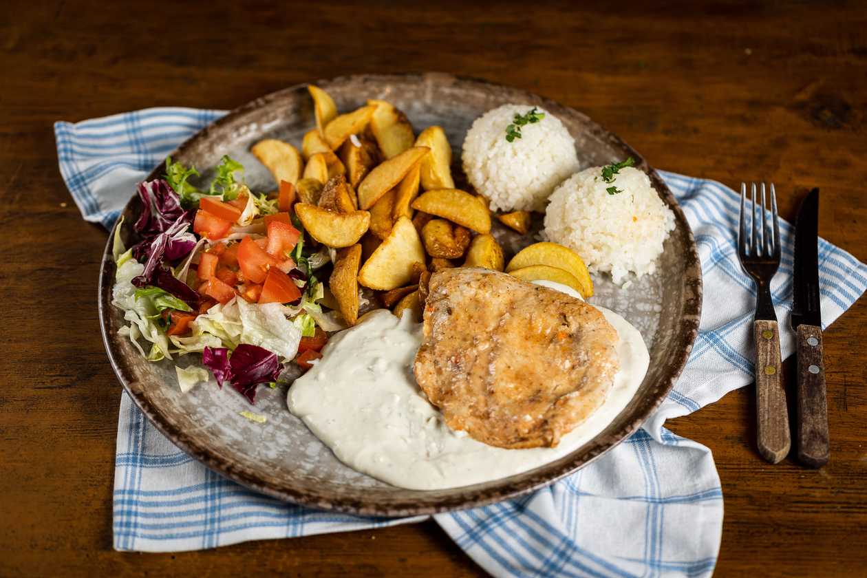 Natural chicken cutlet schnitzel niva blue cheese sauce, 1/2 rice, 1/2 baked potatoes, vegetable garnish
