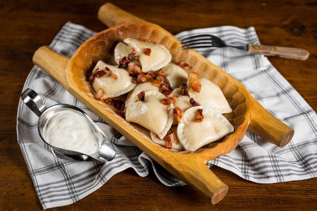 Pierogi with sheep's cheese, butter, bacon and sour cream