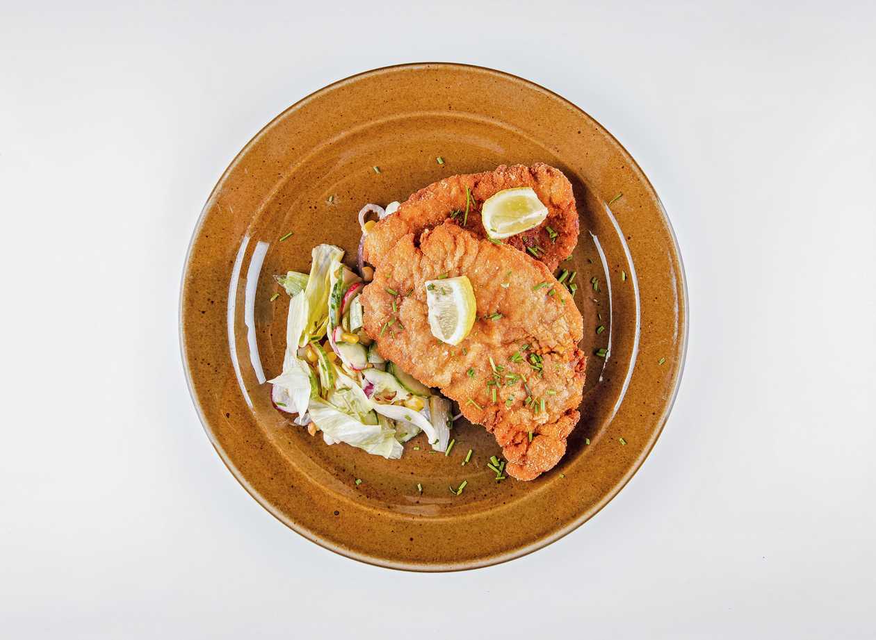 Fried pork tenderloin schnitzel, seasonal vegetable salad