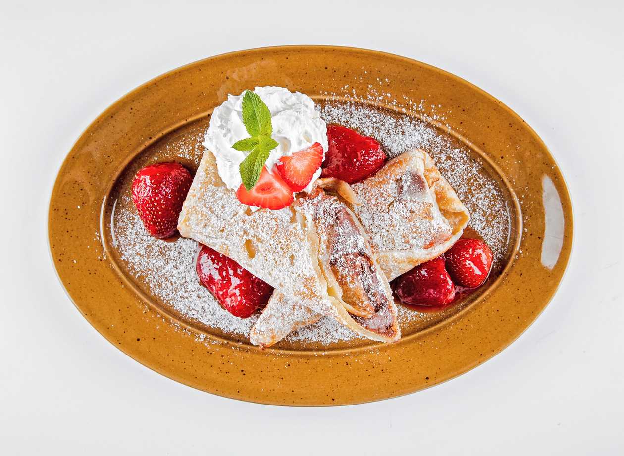 Pancake with nutella, hot forest fruits and homemade whipped cream