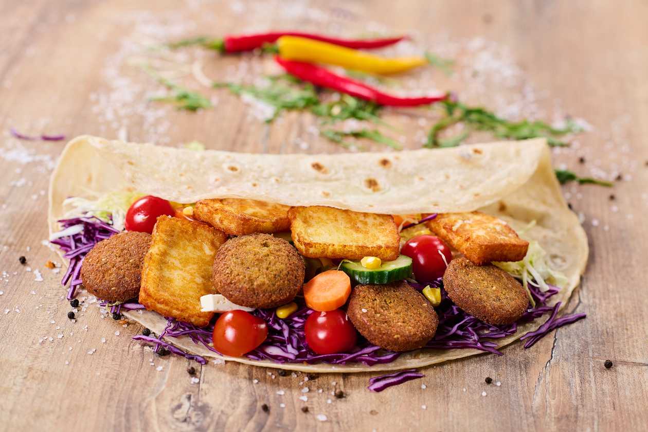 Vegetarian homemade tortilla with falafel and haloumi cheese