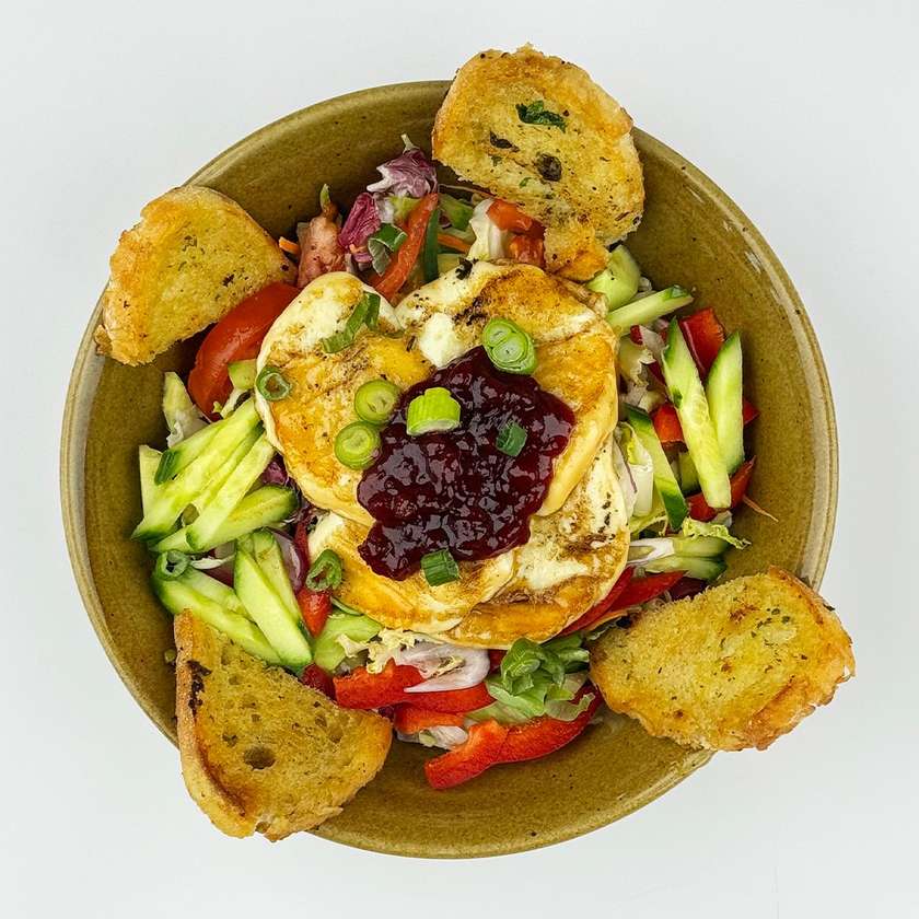 Grilled smoked sheep's cheese with cranberries, mixed leaf and vegetable salad with honey-mustard dressing, sourdough bread