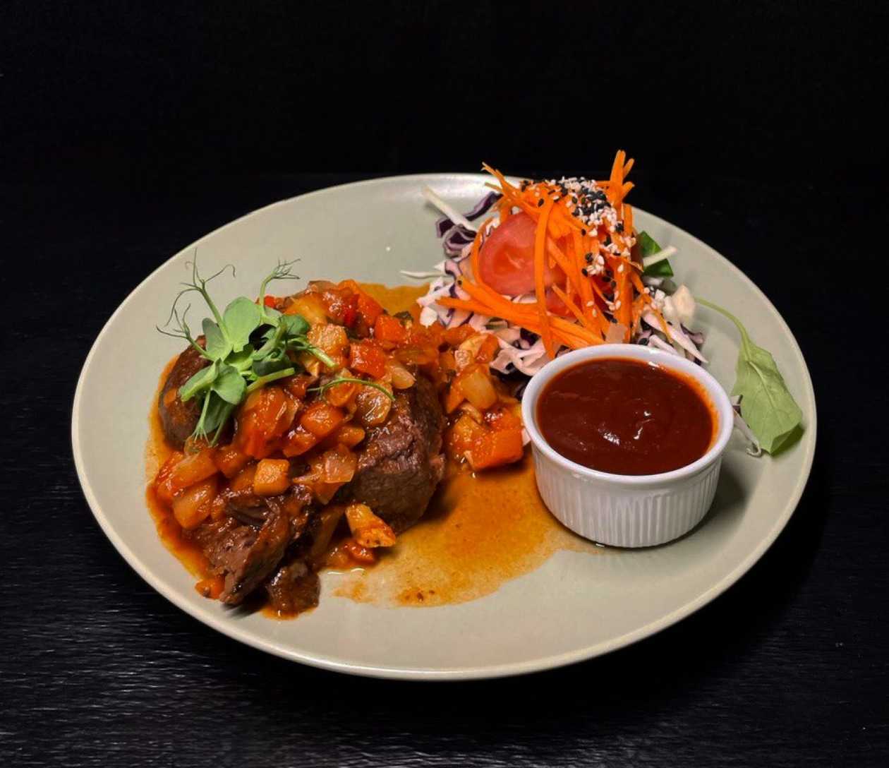 Red wine-braised beef cheeks with oven-baked potatoes, stewed cabbage and whiskey-apple BBQ sauce