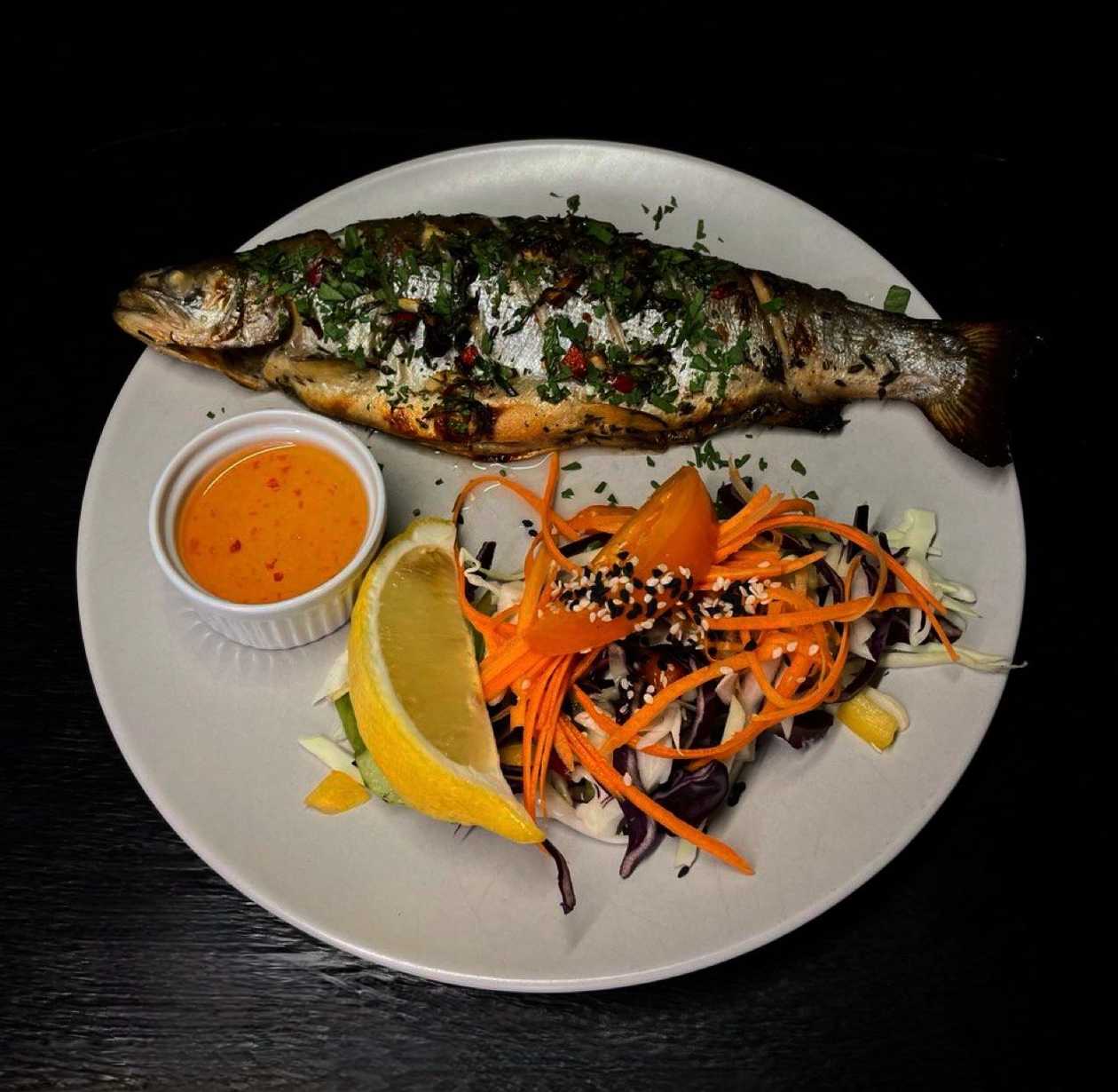 River trout marinated in white wine and parsley with Sicilian style vegetables and honey-lemon sauce