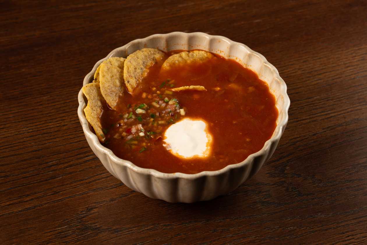 Chili soup with black beans, beef, nachos and fresh salsa