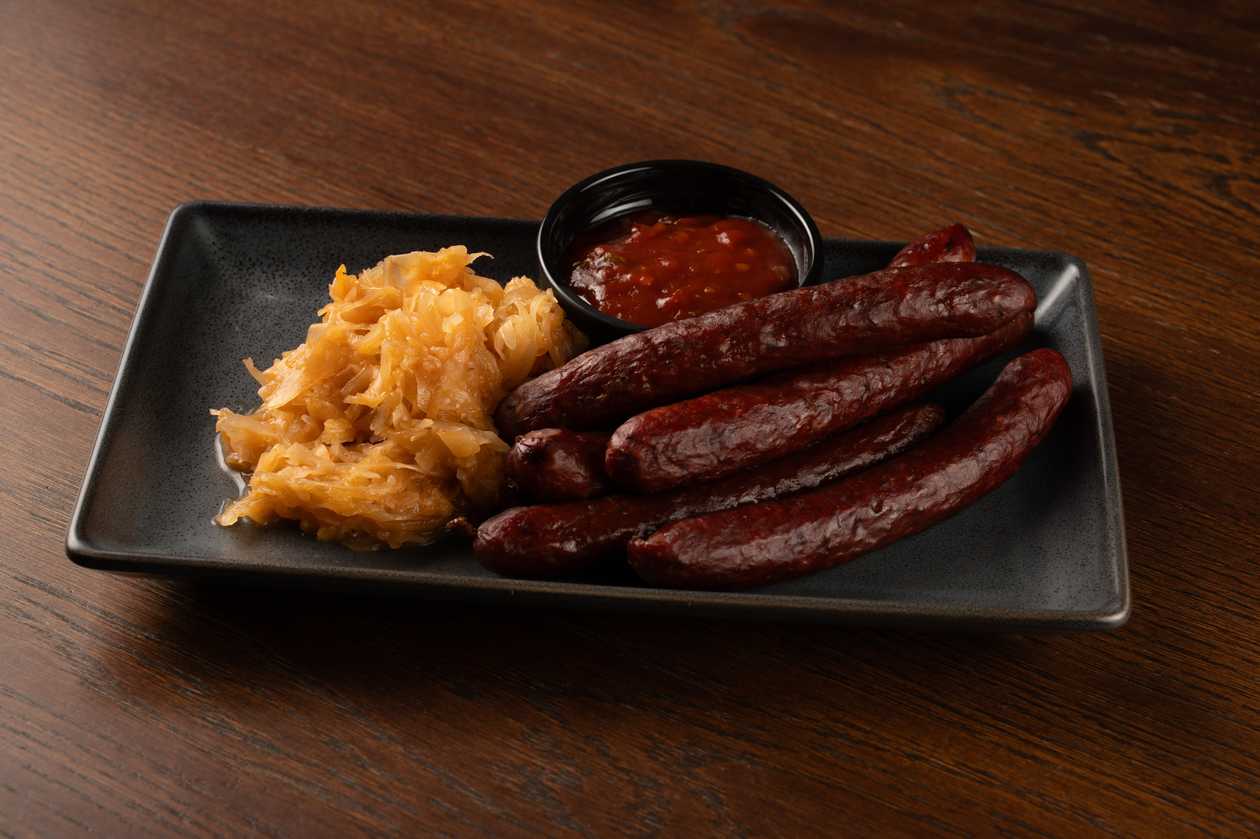 Hunter’s sausages with stewed cabbage and spicy dip
