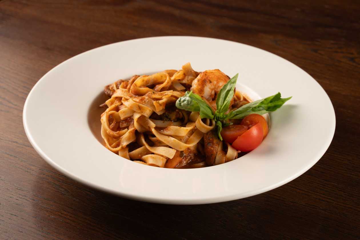 Seafood pasta tagliatelle in tomato-basil sauce